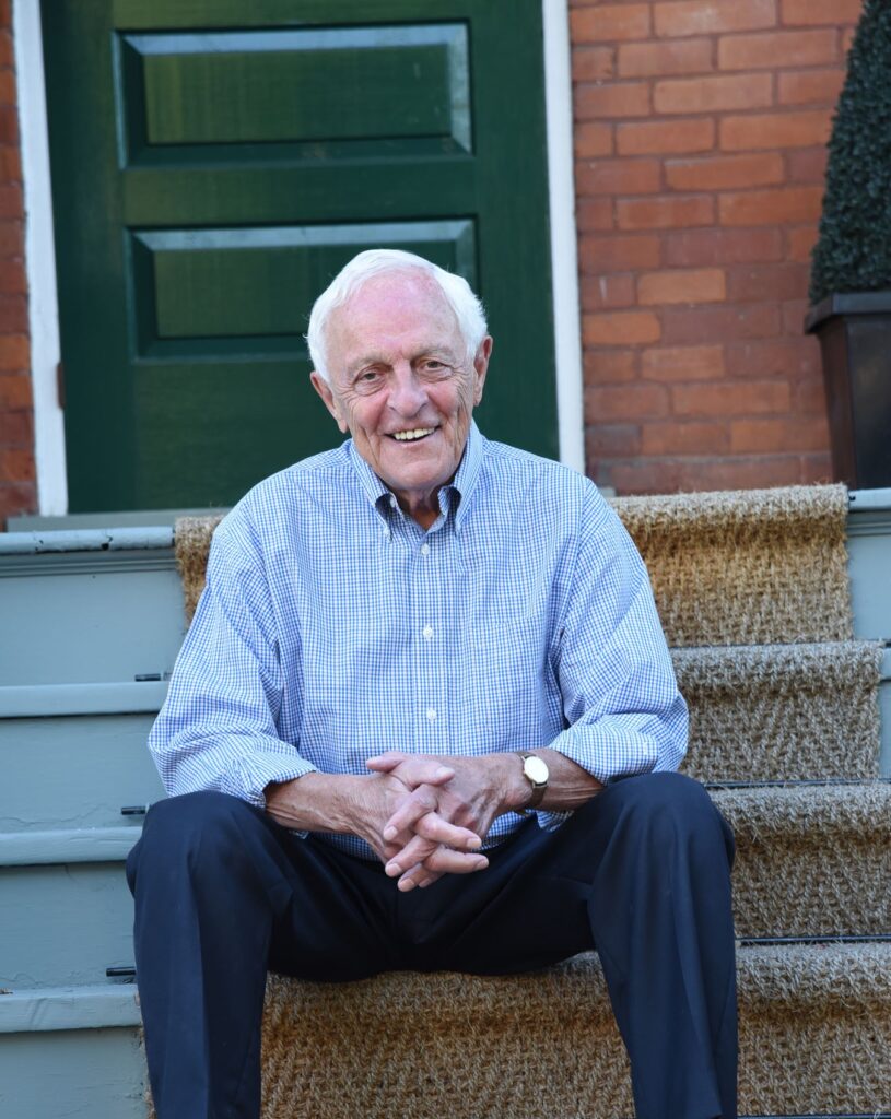 Dr. Paul sitting on a stoop